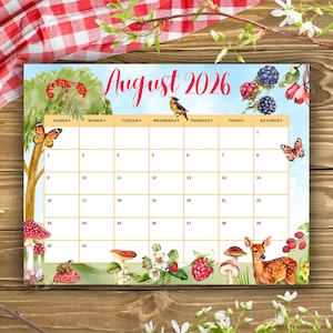 May include: A wall calendar for August 2026 featuring a watercolor illustration of a forest scene with a deer, mushrooms, butterflies, berries, and a small bird. The calendar grid is organized by days of the week with white boxes for dates.