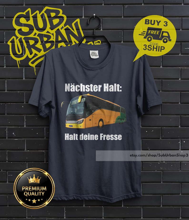 May include: Dark navy blue t-shirt with a graphic of a yellow and green bus and the text "N&auml;chster Halt: Halt deine Fresse". The shirt also features the text "SUB URBAN" in yellow graffiti style.