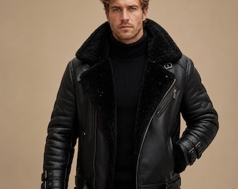 May include: A black leather jacket featuring a thick black shearling lining, a wide notched collar, and an asymmetrical front zipper. The jacket includes adjustable buckled straps on the cuffs and waist, along with a zippered chest pocket.