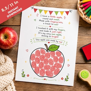 May include: A white printable sheet featuring a poem about an apple made with red fingerprints. The text reads: I have a little apple, round and sweet. Made with fingerprints, a treat to eat! I touched it with my fingers, and made it just right. It's my very own apple, shining so bright! This apple was made by me!