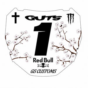 May include: A white motocross number plate decal featuring a large black number 1 in the center. The design includes black text reading GUTS, Red Bull, and GS CUSTOMS, a black cross, a Monster Energy logo, and brown branches with white cherry blossoms.