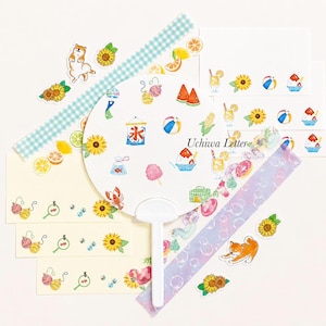 May include: A collection of stationery items featuring summer-themed illustrations. Includes a white fan, decorative tapes, and notecards adorned with images of sunflowers, fruit, and a Shiba Inu dog. The text "Uchiwa Letter" is visible.