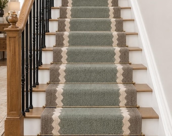 May include: A stair runner featuring a central sage green panel flanked by brown borders, separated by a cream-coloured zigzag pattern. The runner is secured with horizontal brass rods on each step and finished with a fringed edge at the bottom.