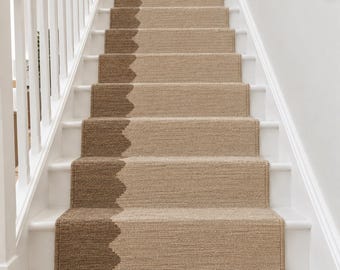 May include: A stair runner featuring a woven texture with a two-tone design. The runner displays a light beige base colour on the right side and a darker brown colour on the left side, separated by a scalloped, wave-like pattern running vertically.