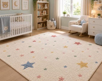 May include: A rectangular area rug with a cream-coloured textured base featuring a scattered pattern of embroidered stars in various sizes and colours, including blue, yellow, pink, and green, distributed across the entire surface.