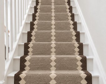 May include: A stair runner featuring a textured, woven pattern in shades of taupe and dark brown. The design consists of a central column of light cream diamonds flanked by dark brown borders, running vertically up the centre of the staircase.