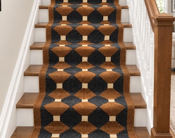 May include: A long stair runner rug featuring a repeating geometric pattern of dark charcoal diamonds and brown octagons separated by small cream-coloured squares. The runner has a textured, woven appearance and includes fringed ends at the bottom.