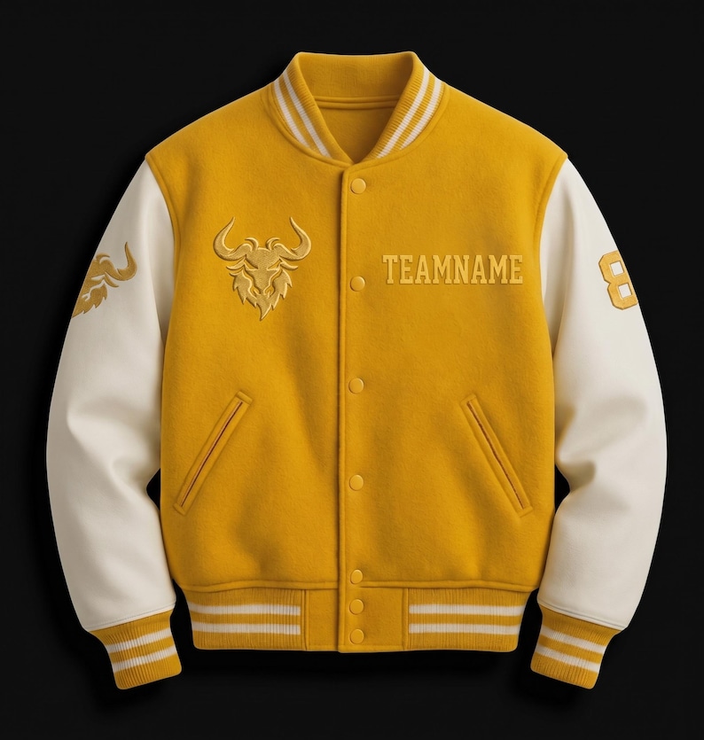 May include: A yellow varsity jacket with cream-colored sleeves. The jacket features a bull logo and the word "TEAMNAME" embroidered in gold. The number "8" is on the right sleeve. Ribbed cuffs and collar have white stripes.