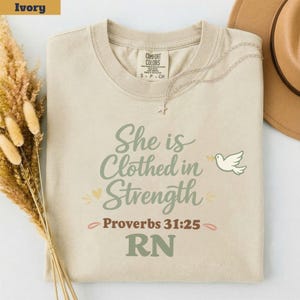 RN Scripture Shirt She Is Clothed in Strength Tee, Proverbs 31 Christian Nurse Shirt, Bible Verse RN Gift, Comfort Colors Faith Nurse Tee