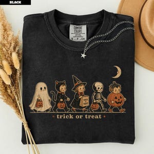 Black t-shirt with vintage Halloween characters and "trick or treat" text.