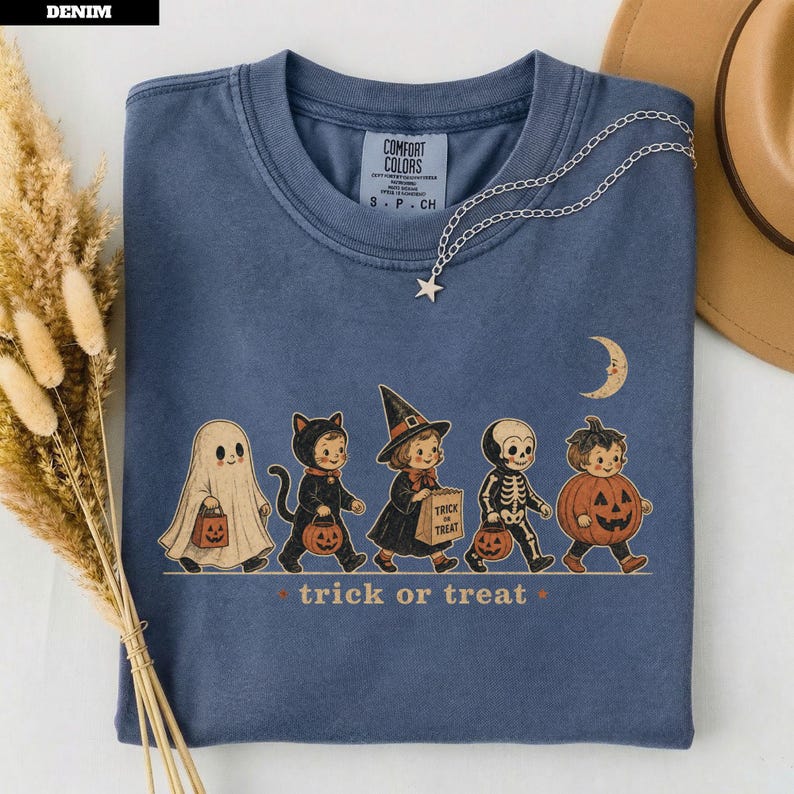 Blue t-shirt with Halloween characters and "trick or treat" text.