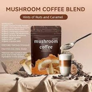 May include: A brown bag of "mushroom coffee" with the text "Hints of Nuts and Caramel" and a cup of coffee with a spoon. The image also includes mushrooms, coffee beans, and a piece of stone.