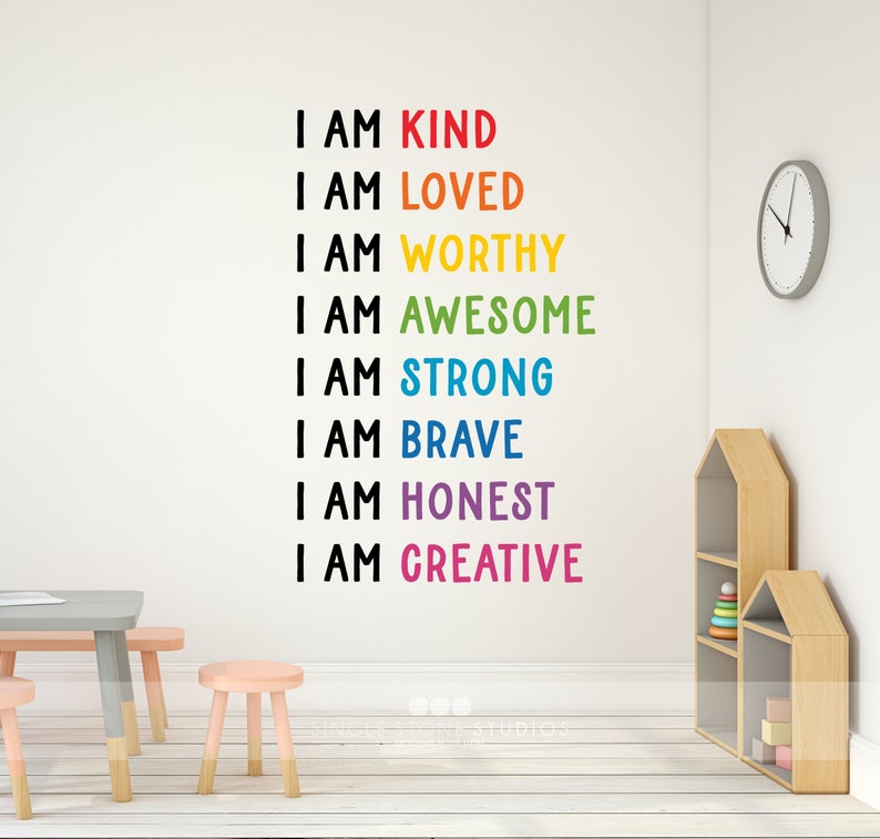 May include: A white wall with a rainbow-coloured motivational quote that reads "I am kind, I am loved, I am worthy, I am awesome, I am strong, I am brave, I am honest, I am creative".