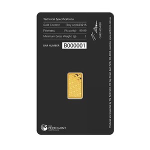 May include: A small rectangular gold bar set in a black assay card. The card displays technical specifications including Gold Content 0.03215 Troy oz, Fineness 99.99%, and Minimum Gross Weight 1 g. The bar number B000001 is printed on the card.