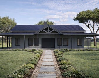 May include: A gray, single-story house with a dark blue roof and a covered porch. A stone pathway leads to the front door, surrounded by green grass and landscaping. The sky is blue with some clouds.
