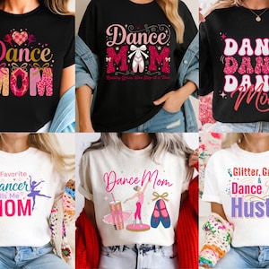 Puede incluir: Colección de camisetas negras y blancas con gráficos temáticos de baile. Los diseños incluyen "Dance Mom" con zapatillas de ballet, una silueta de bailarina y las frases "Glitter, Grace & Dance Mom Hustle" y "My Favorite Dancer Calls Me Mom."