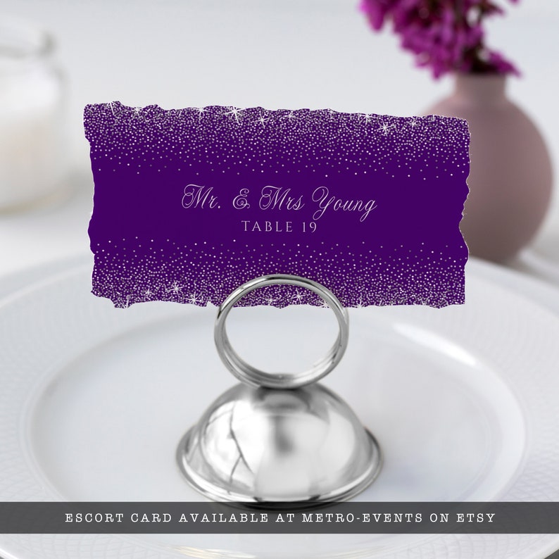 A glam style sweet sixteen and quinceanera escort card. This glittery design is created with faux silver glitter on a purple background and a princess crown. Designed by MetroEvents.