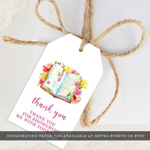 May include: White favor tag with a watercolor illustration of an open book with pink, yellow, and red flowers. The text "thank you" is written in pink script and the text "Thank you for showering me with your love" is written in black.