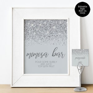 Sparkling Silver Glitter Mimosa Bar Sign and Tags. A glam style sign is created with faux silver glitter on a coordinating silver background with elegant text. Designed By MetroEvents.