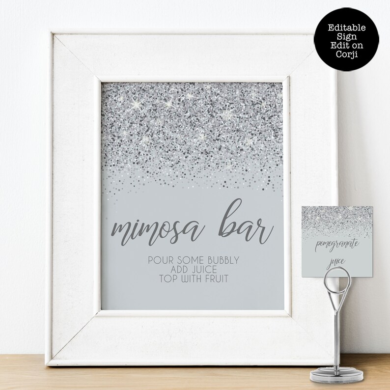 Sparkling Silver Glitter Mimosa Bar Sign and Tags. A glam style sign is created with faux silver glitter on a coordinating silver background with elegant text. Designed By MetroEvents.