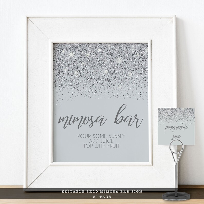 Sparkling Silver Glitter Mimosa Bar Sign and Tags. A glam style sign is created with faux silver glitter on a coordinating silver background with elegant text. Designed By MetroEvents.