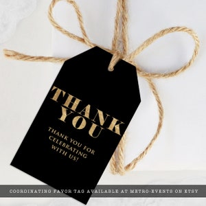 May include: A black gift tag with gold text that reads "THANK YOU" and "THANK YOU FOR CELEBRATING WITH US!". The tag is tied with a natural twine bow. The tag is a favor tag.