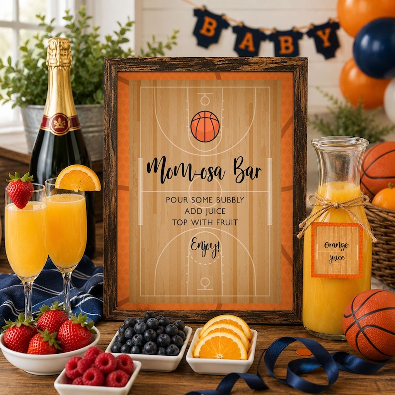 May include: A framed sign with a basketball court design and the text Mom-osa Bar, Pour some bubbly, Add juice, Top with fruit, Enjoy. The sign is surrounded by a bottle of champagne, two glasses of orange juice, bowls of berries, and orange slices.