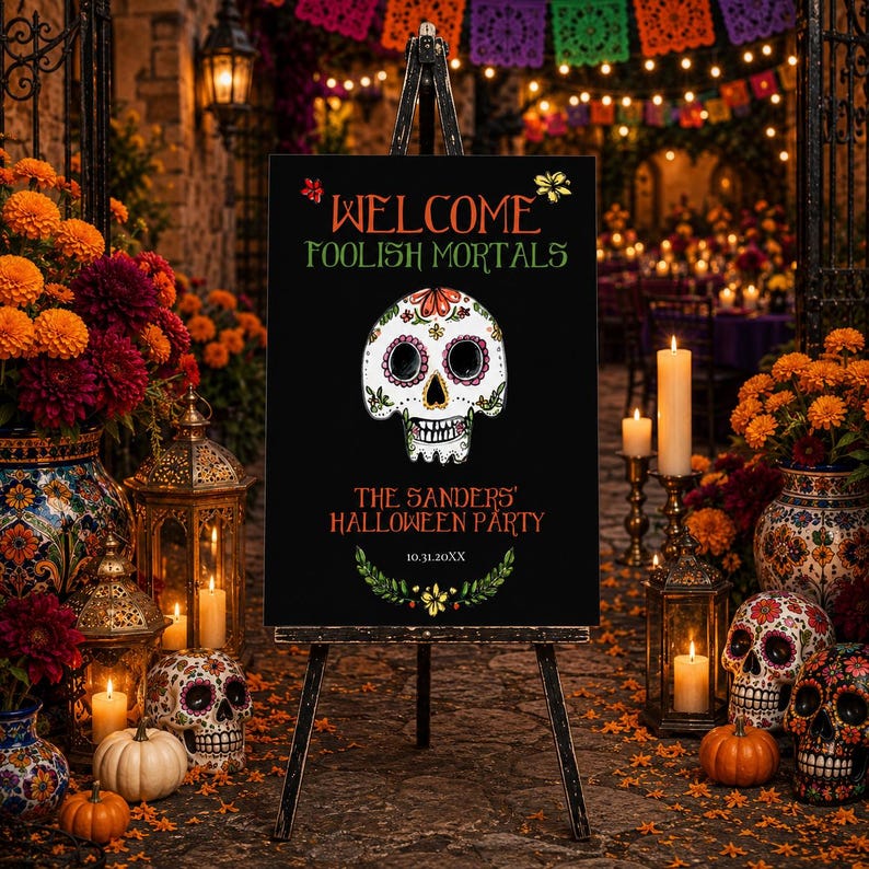 May include: A black rectangular sign on a tripod stand featuring a white sugar skull illustration, orange and green text reading WELCOME FOOLISH MORTALS, THE SANDERS' HALLOWEEN PARTY, and 10.31.20XX, accented with green leaf and yellow flower graphics.