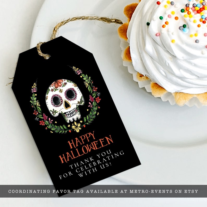 Day of the dead themed favor tag a watercolor-style sugar skull with flower and leaf accents on a black background. Designed By MetroEvents