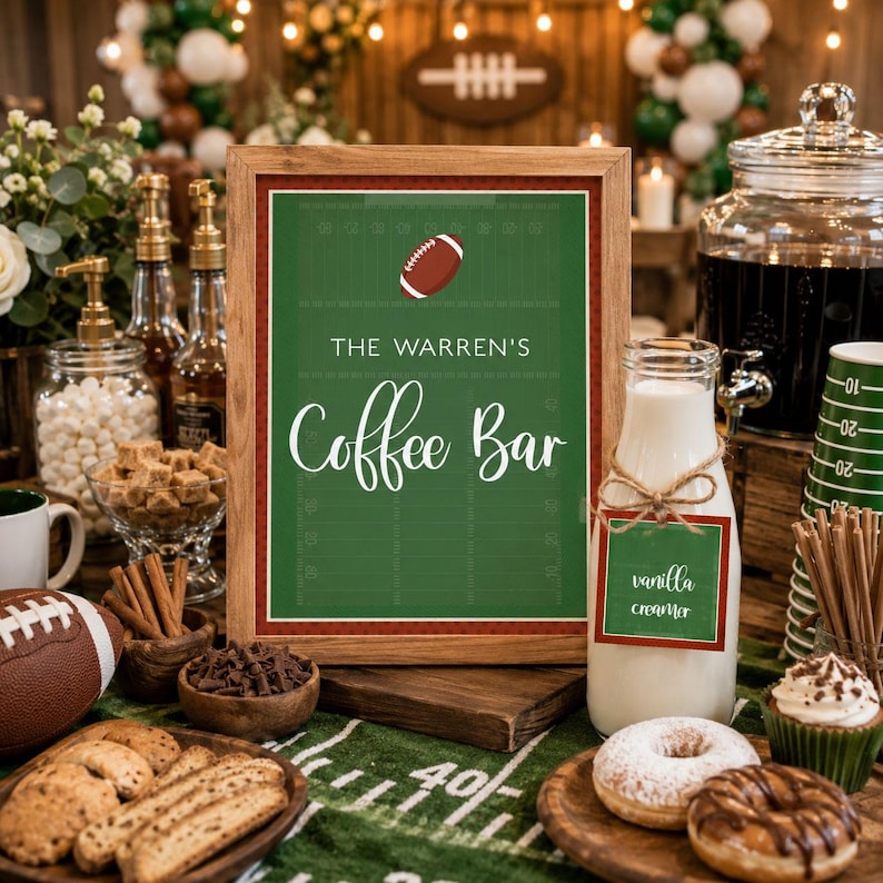 May include: A framed sign with a green football field background, white text reading THE WARREN'S Coffee Bar, and a football graphic. Next to it is a glass bottle of vanilla creamer with a matching tag, donuts, cookies, and a football.