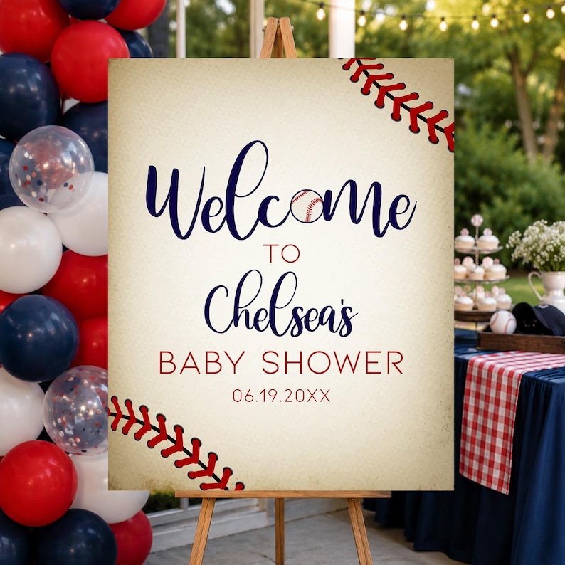 May include: A baseball-themed baby shower welcome sign on a wooden easel. The sign reads "Welcome to Chelsea's Baby Shower" with a baseball graphic and the date. Red and blue balloons are in the background.