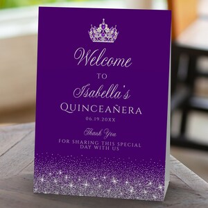 A glam style sweet sixteen and quinceanera welcome sign. This glittery design is created with faux silver glitter on a purple background and a princess crown. Designed by MetroEvents.