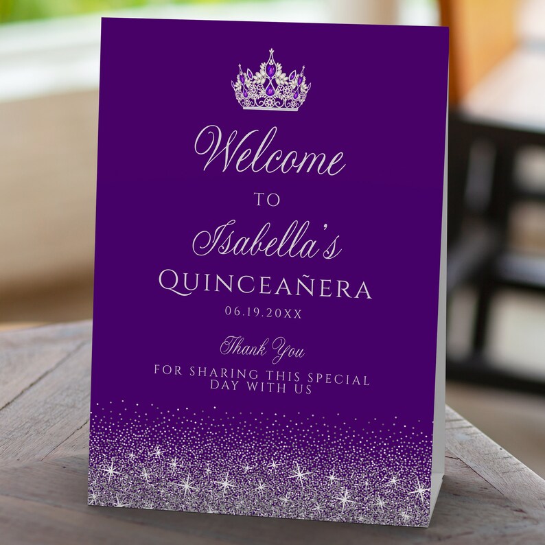 A glam style sweet sixteen and quinceanera welcome sign. This glittery design is created with faux silver glitter on a purple background and a princess crown. Designed by MetroEvents.
