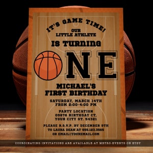 Basketball-themed first birthday invitations. Featuring a basketball court and ball background accented with a basketball and customizable typography. Designed By MetroEvents