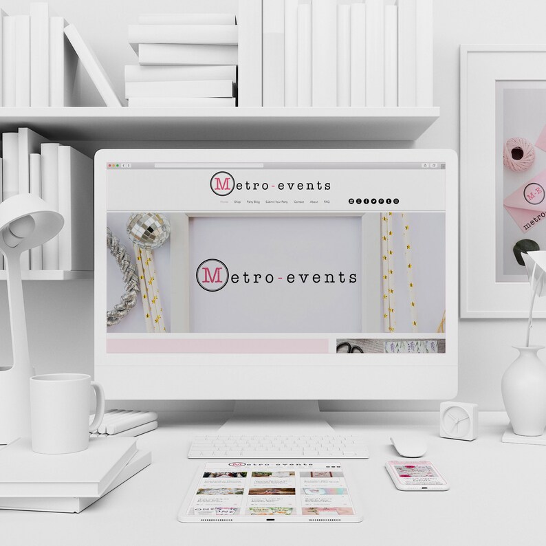 May include: A modern workspace featuring a computer displaying the "Metro-events" website. The desk includes a tablet, smartphone, keyboard, mouse, lamp, mug, and books. A framed picture and decorative items are also present.
