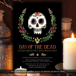 May include: A black rectangular invitation card featuring a white sugar skull illustration surrounded by a colorful floral wreath. The text reads: DAY OF THE DEAD, PLEASE JOIN US FOR A HALLOWEEN PARTY, SATURDAY, OCTOBER 31 AT SIX O'CLOCK.