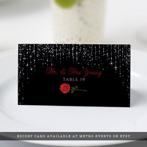 Editable name cards, escort cards, or place cards For sweet 16 parties or Quinceanera features silver sparkles falling from the top of a black background with red rose accents. Designed By MetroEvents.