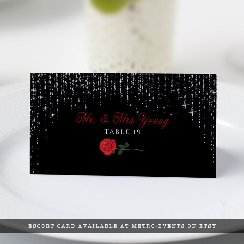 Editable name cards, escort cards, or place cards For sweet 16 parties or Quinceanera features silver sparkles falling from the top of a black background with red rose accents. Designed By MetroEvents.