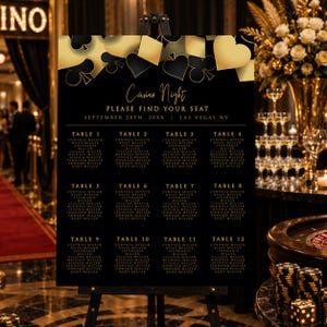 May include: A black and gold casino night seating chart sign on an easel. The top features playing card suit icons. Text reads: Casino Night, Please Find Your Seat, September 28th, 20XX, Las Vegas NV, and lists tables 1 through 12 with names.