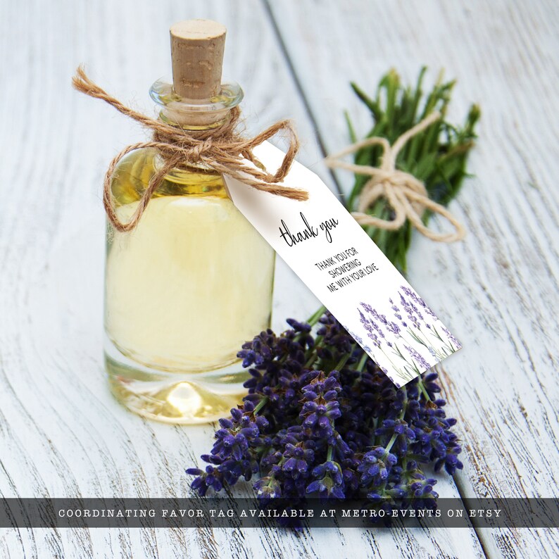 May include: A small glass bottle filled with a clear liquid, tied with twine and a white tag that reads "thank you" with lavender flowers in the background. The tag also says "Thank you for showering me with your love".