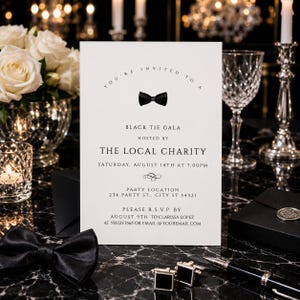 May include: A white rectangular invitation card with black text and a black bow tie graphic. The text reads: You're invited to a Black Tie Gala hosted by The Local Charity, Saturday, August 14th at 7:00pm, Party Location 234 Party St., City St 54321, Please R.S.V.P. by August 9th to Clarissa Lopez at 555.123.3565 or email @ youremail.com.