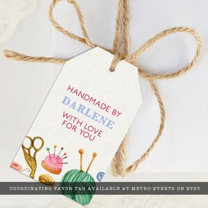 May include: A white gift tag with the text "Handmade by Darlene with love for you". The tag is decorated with a watercolor illustration of sewing supplies, including scissors, spools of thread, and a pincushion.