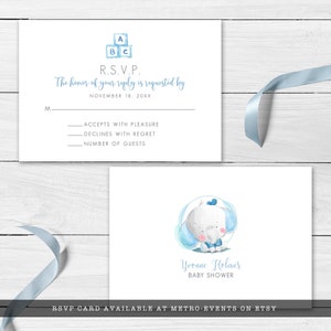 May include: Baby shower RSVP card with a watercolor illustration of a baby elephant. The card includes the text "Yvonne Holmes BABY SHOWER" and a space for guests to respond. The top of the card features blue ABC blocks.