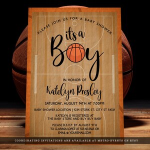 May include: A rectangular baby shower invitation card featuring a basketball court wood grain background. The text reads: Please join us for a baby shower, it's a boy, in honor of Katelyn Presley, Saturday, August 14th at 7:00PM, and registry details.