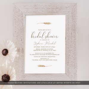 May include: A white bridal shower invitation with gold wheat stalks and calligraphy text. The invitation reads "Please join us for a bridal shower in honor of Stephanie Marshal. Saturday, March 14th at 3:00pm. Bridal Shower Location 09876 Bridal Ct, Wedding city St. 54321. Please R.S.V.P. by December 9th to Laura Dean at 555.123.3565 or email@youremail.com. Hosted by Stephanie's Bridesmaids. Registered at The Bridal Shop and Somewhere Online."