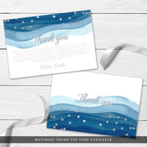 May include: Two white thank you cards with a watercolor design in shades of blue and silver accents. The cards feature the text "Thank you" in silver script. Additional text is present.