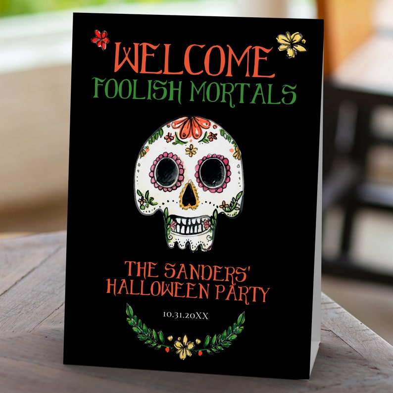 Day of the dead themed welcome sign a watercolor-style sugar skull with flower and leaf accents on a black background. Designed By MetroEvents