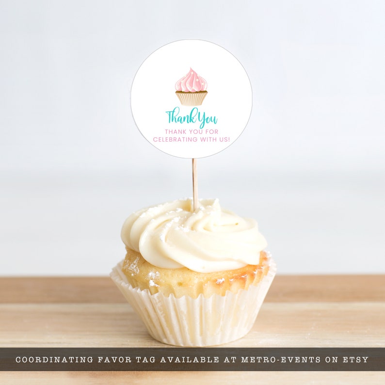 May include: A cupcake with white frosting and a round topper. The topper features a pink cupcake illustration and the words "Thank You" and "Thank You for Celebrating with Us!"