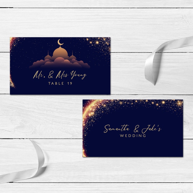 May include: Two rectangular navy blue cards with gold text and accents. One card features a gold mosque silhouette under a crescent moon with the text Mr. & Mrs. Young TABLE 19. The other card displays gold glittery star patterns and the text Samantha & Jake's WEDDING.
