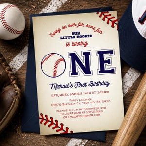 May include: Baseball-themed first birthday invitation with a baseball graphic and the word "ONE" in navy blue. The invitation includes the text "Swing on over for some fun" and event details. A baseball, glove, and cap are in the background.